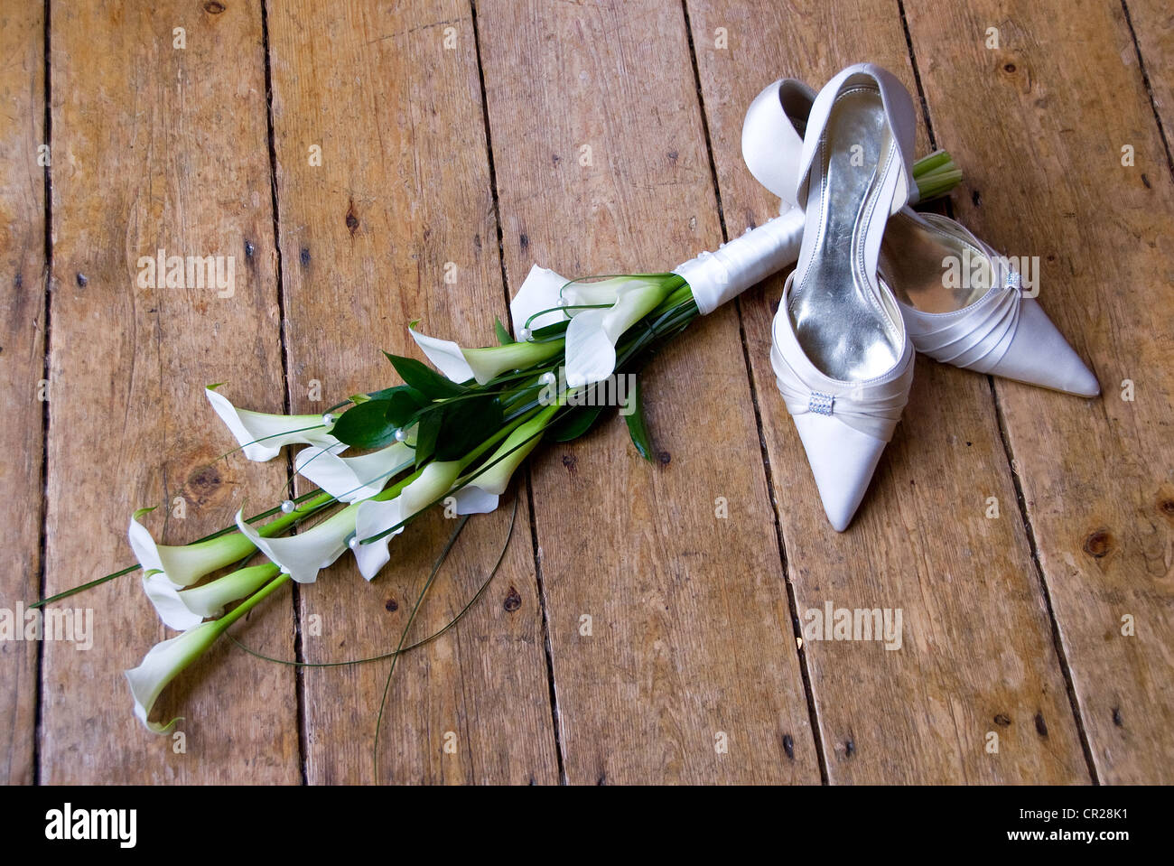wedding shoes and calla lilies Stock Photo