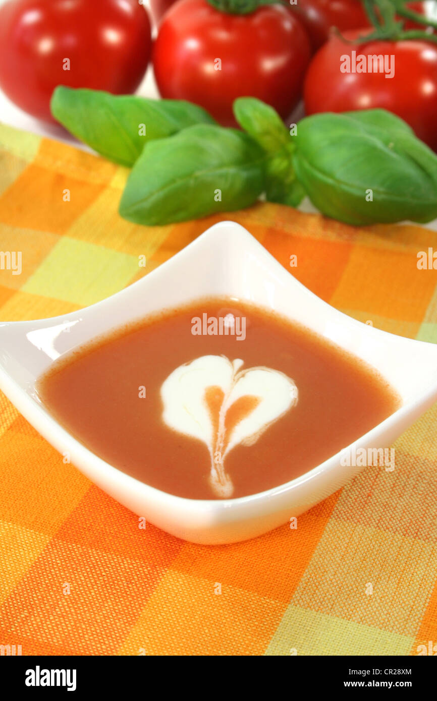 tomato cream soup with dollop of whipped cream in a cup of soup Stock Photo