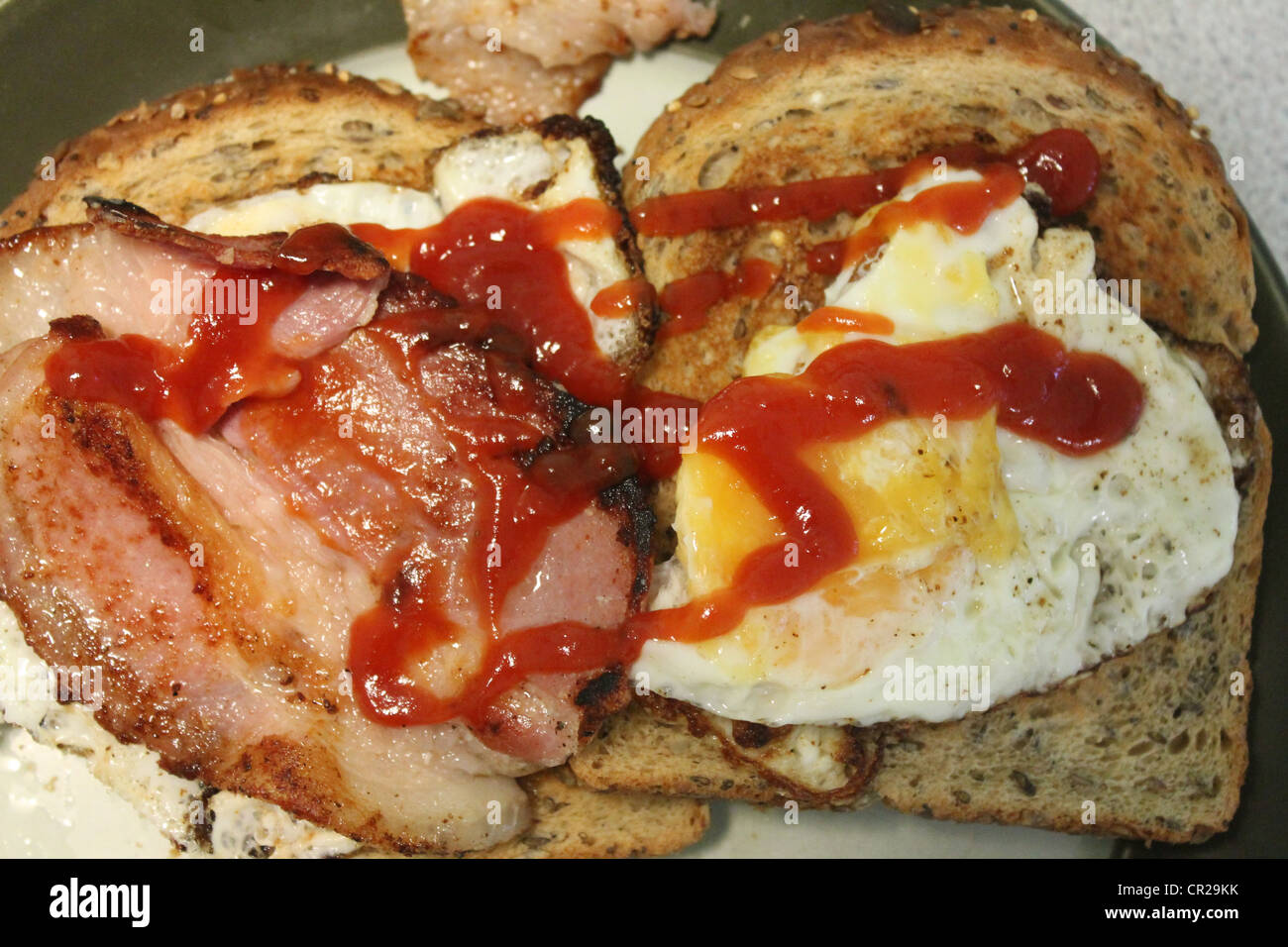 Fried breakfast of fried eggs and bacon with ketchup Stock Photo