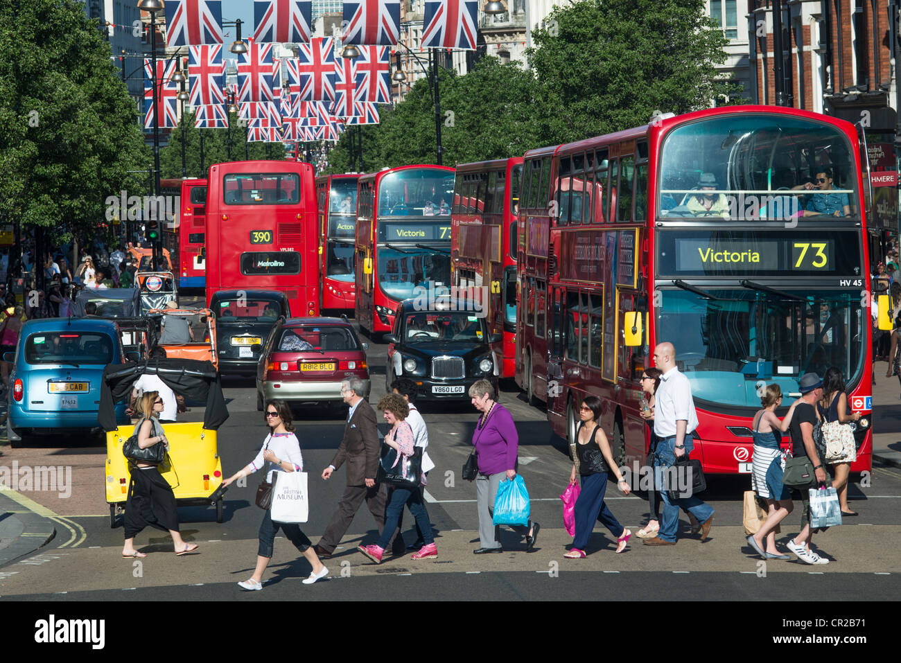 A busy Oxford Street with shoppers and red buses. London, England. Stock Photo