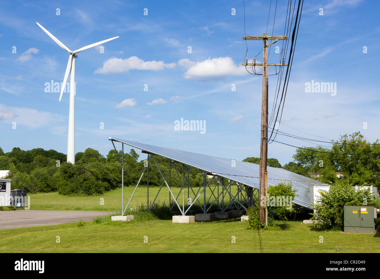 Wind Turbine and Solar Panels. Green energy in an industrial park in Newburyport, MA. Stock Photo