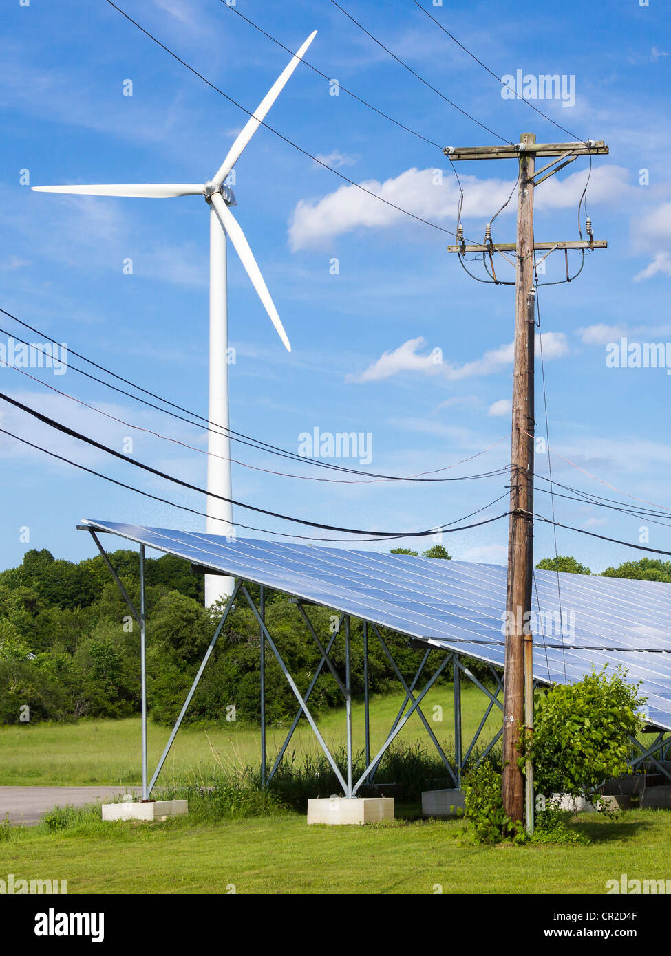 Wind Turbine and Solar Panels. Green energy in an industrial park in Newburyport, MA. Stock Photo