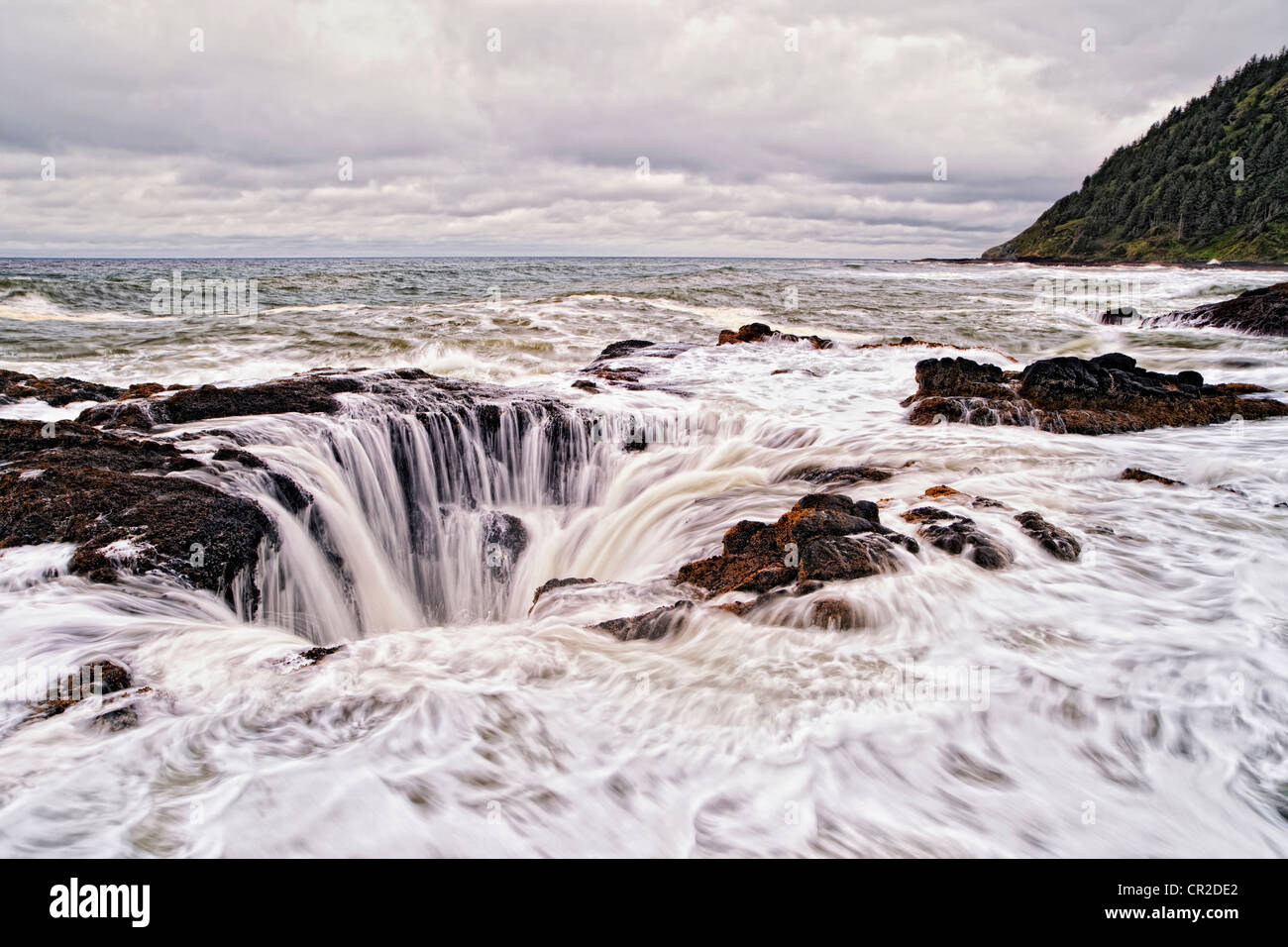 Thor’s Well is constantly replenished by the storm driven high tide at Oregon’s Cape Perpetua Scenic Area. Stock Photo