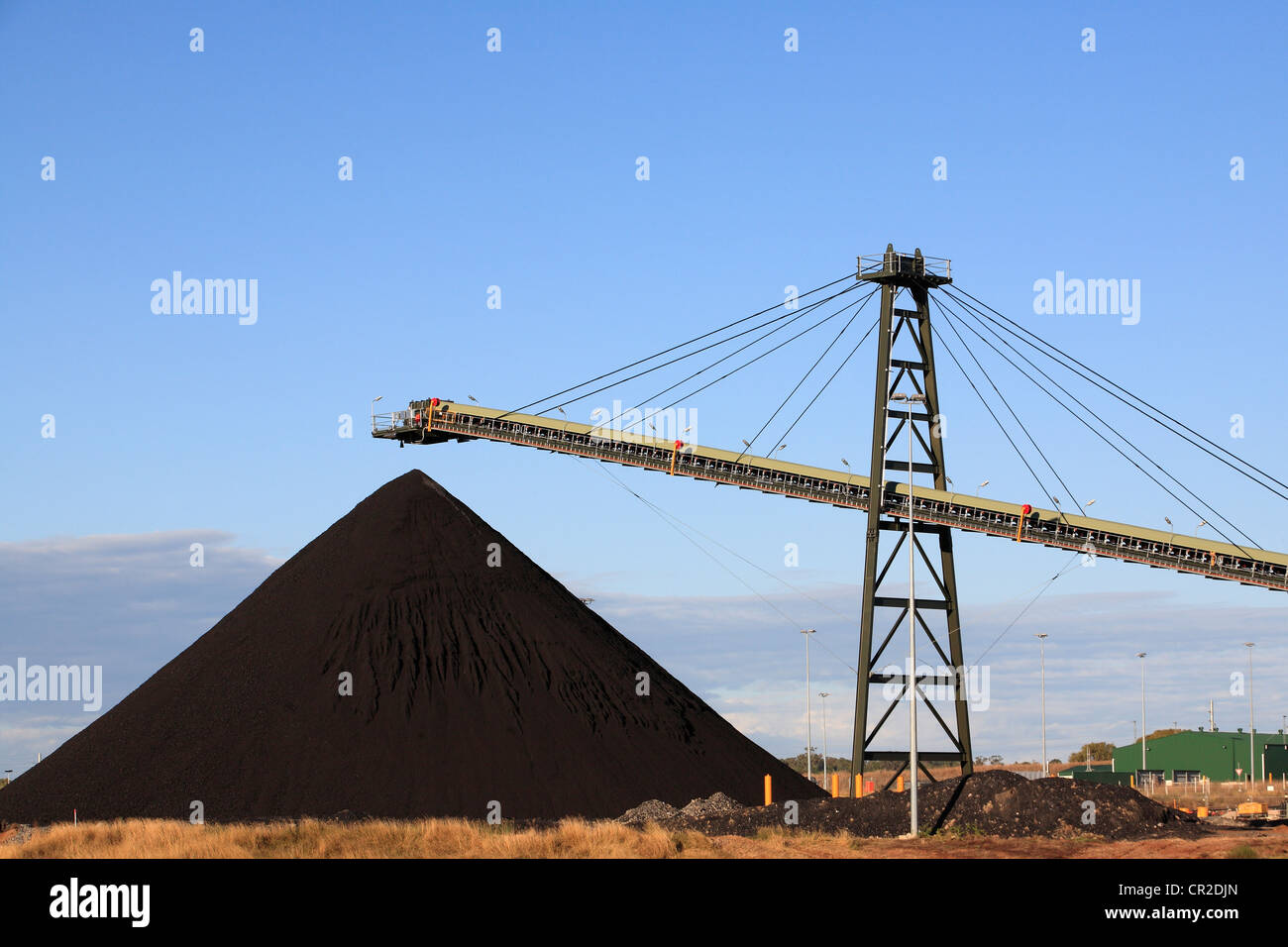 Coal Loading Conveyor Belt and a Pile of Coal at a Coal Mine Stock Photo