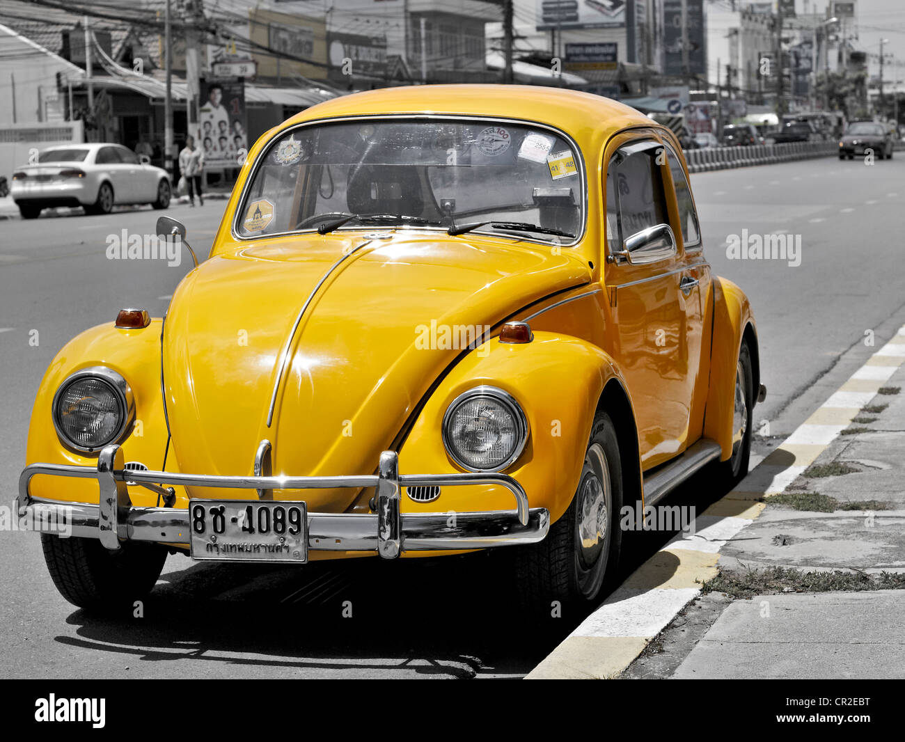 Vintage Yellow Volkswagen Beetle parked at the roadside. Thailand Asia Stock Photo