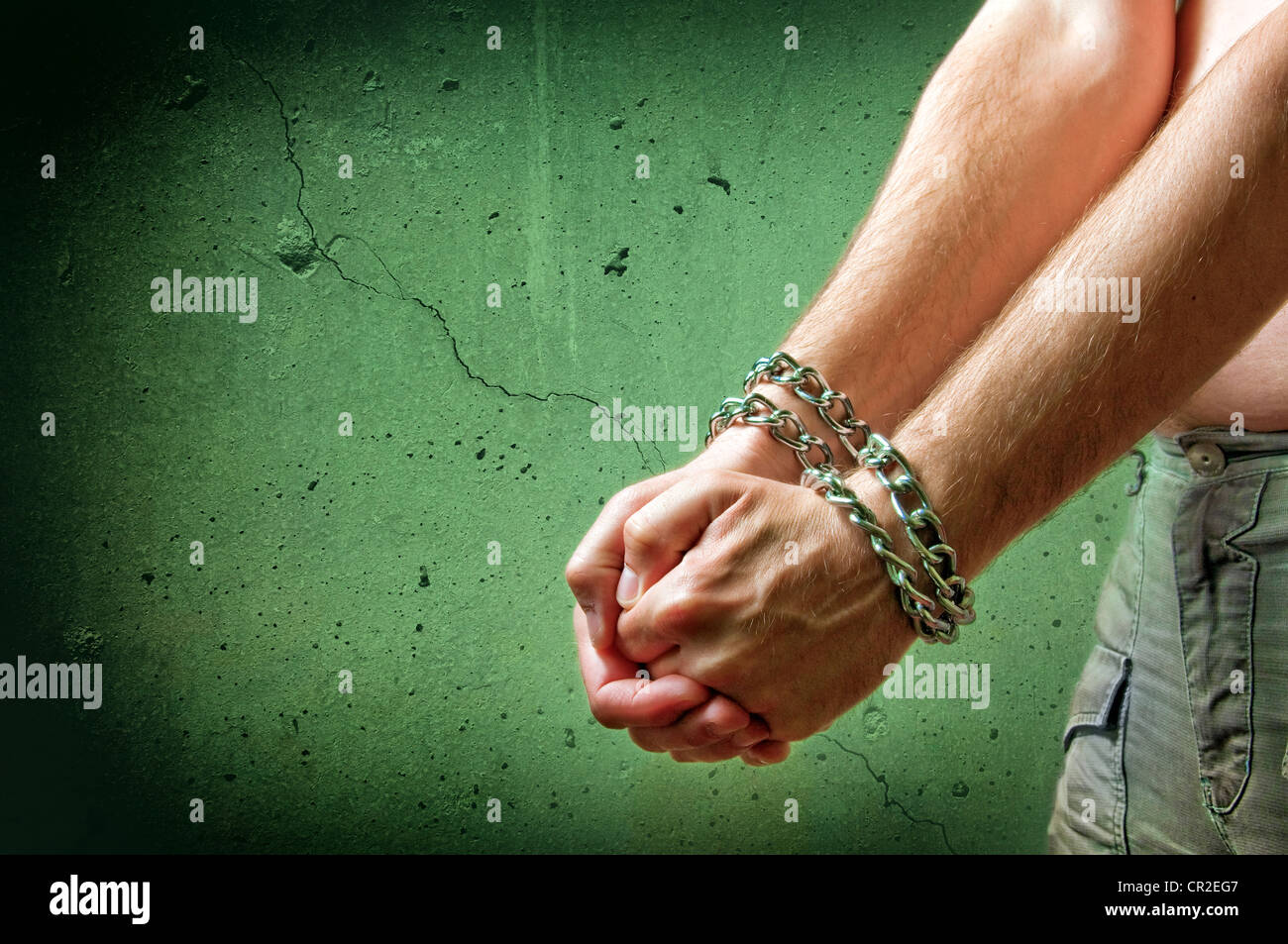 Male hands with chain wrapped around them, prisoner concept Stock Photo