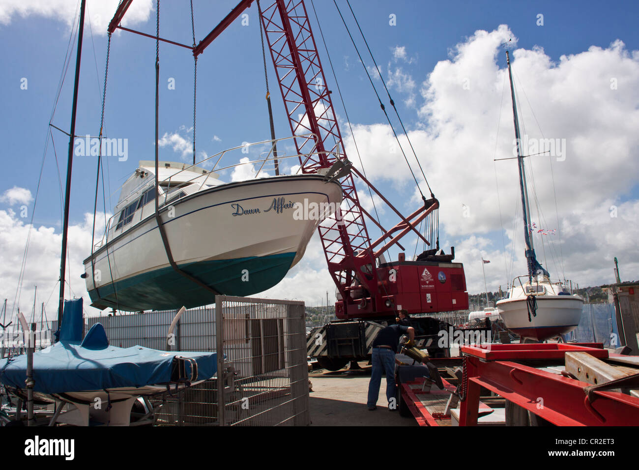 Motor yacht (Dawn Affair) being offloaded from lorry in the marine at Torquay, Devon,UK. Stock Photo