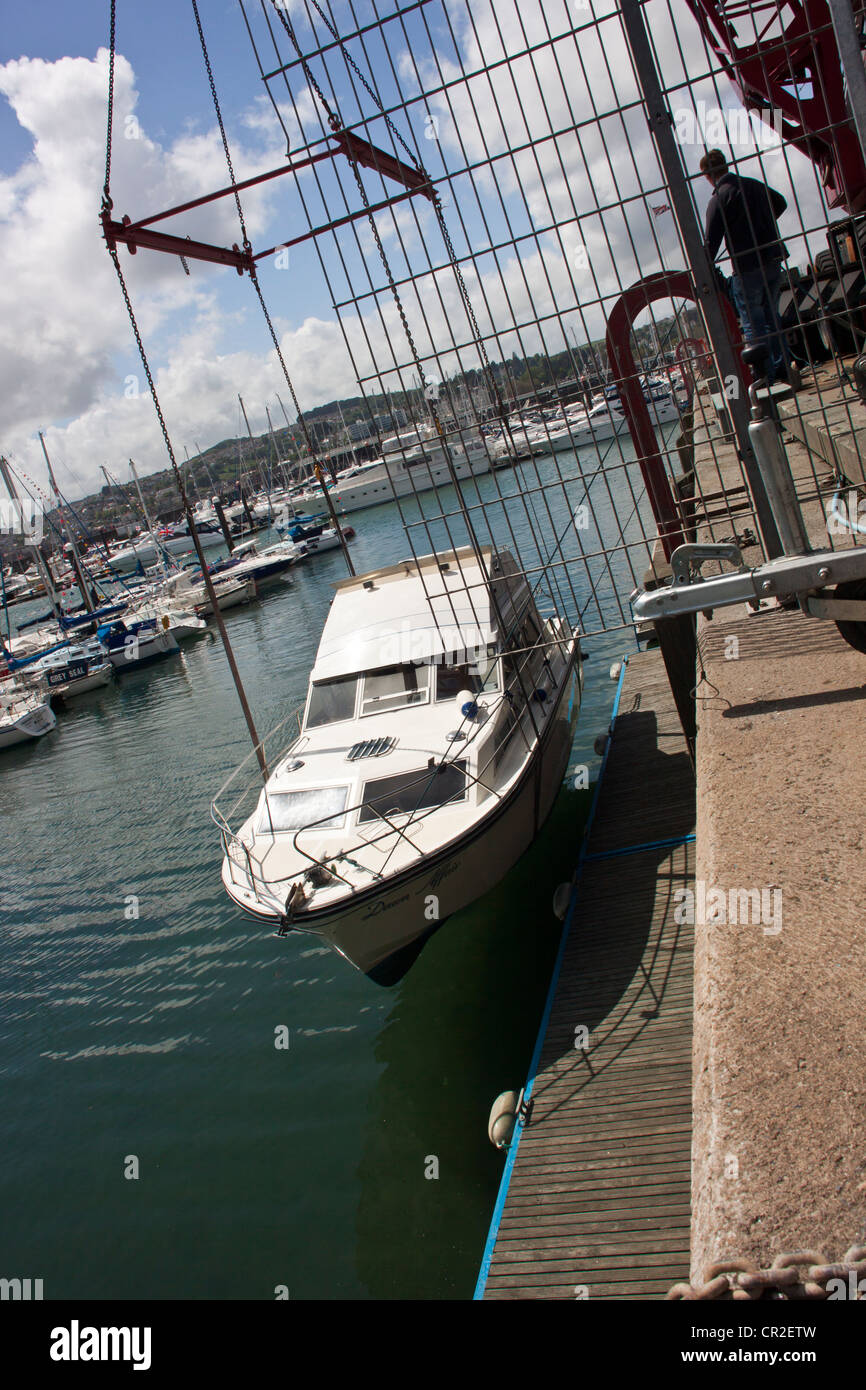 Motor yacht (Dawn Affair) being offloaded from lorry in the marine at Torquay, Devon,UK. Stock Photo