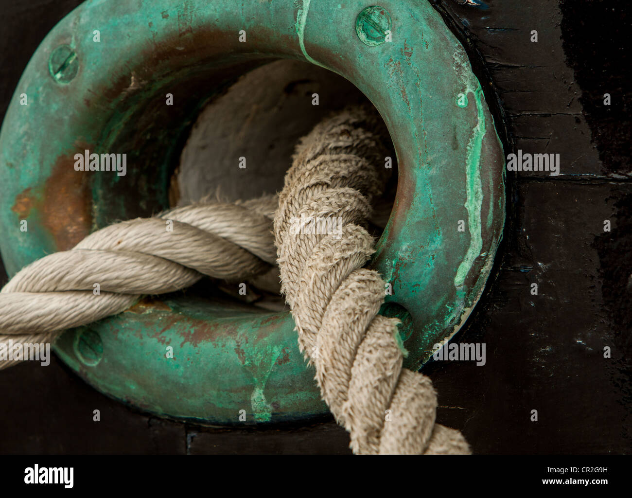 Mooring lines coming out of a hole in a ship Stock Photo Alamy