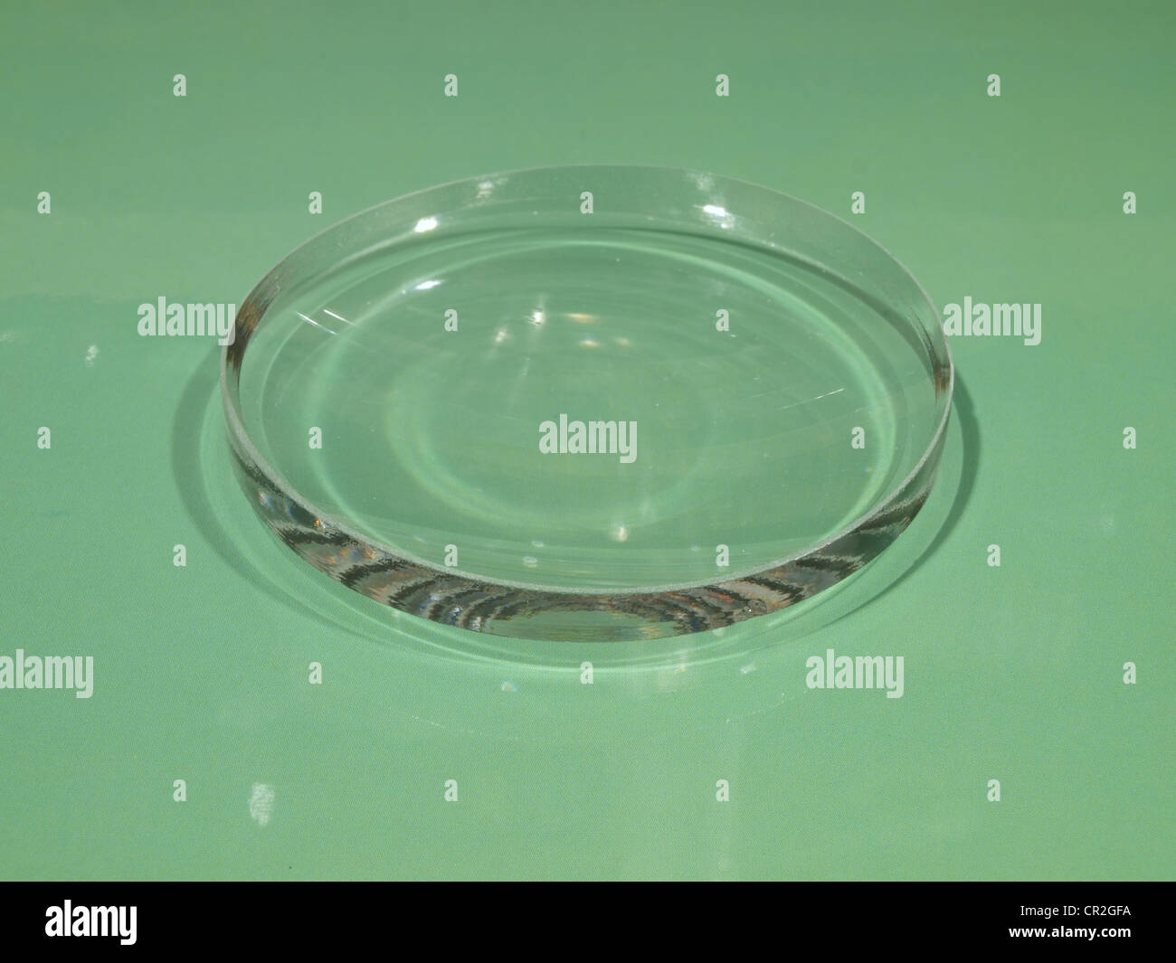 Glass lens on a green background Stock Photo