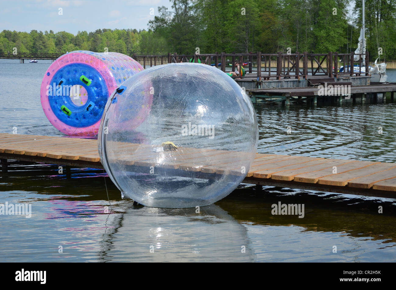 Zorbing air bubbles on water. Marina resort lake in Trakai. Most visited tourist place in Lithuania. Stock Photo