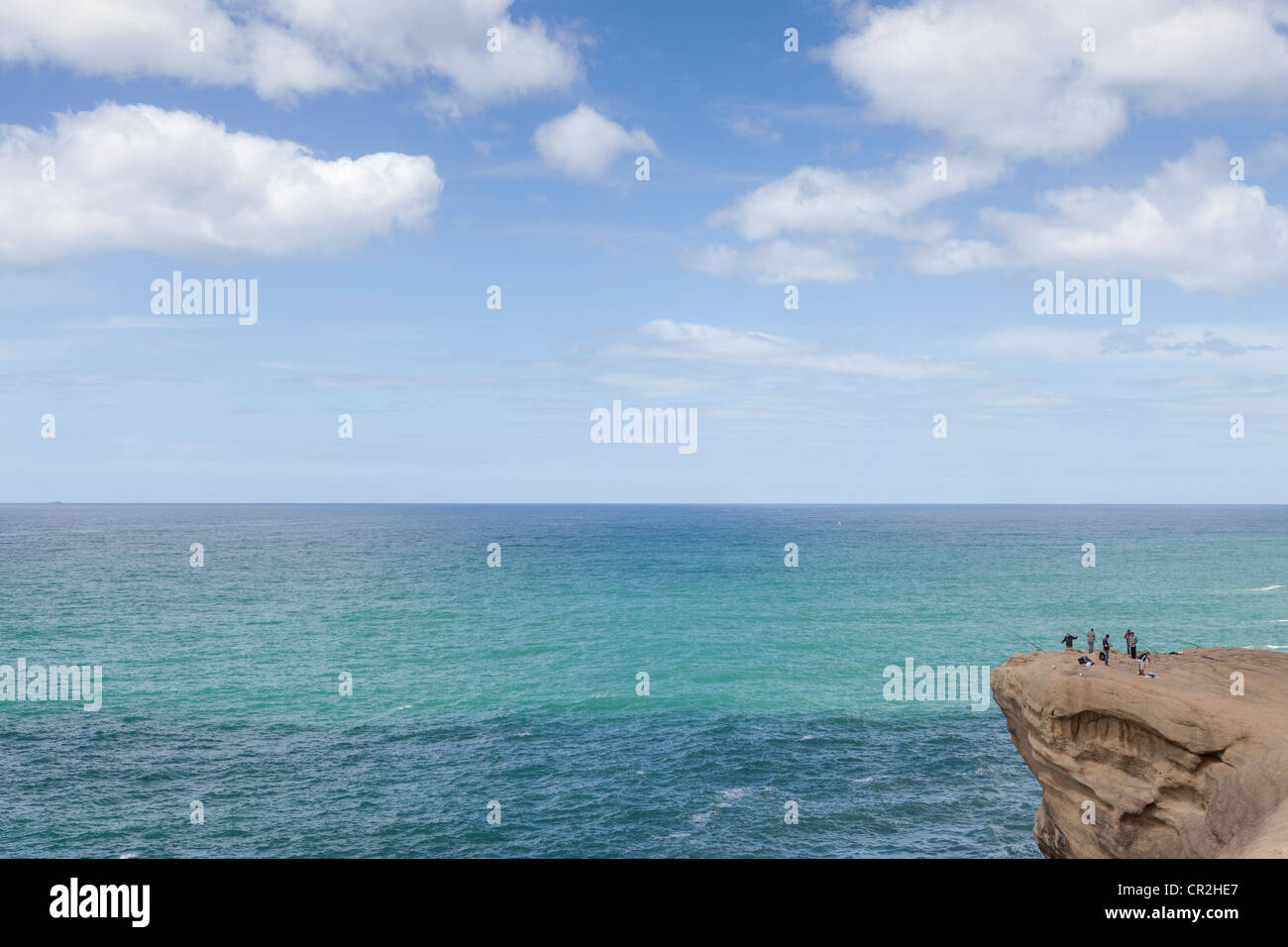 People fishing on a cliff at Castlepoint, Wairarapa coast, Wellington, New Zealand, Oceania Stock Photo