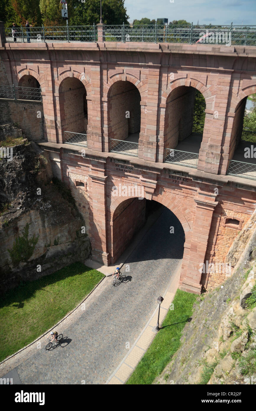 Cyclists pass under the viaduct Schloss Erbaut Bruecke, Luxembourg city, the Grand Duchy Luxembourg. Stock Photo