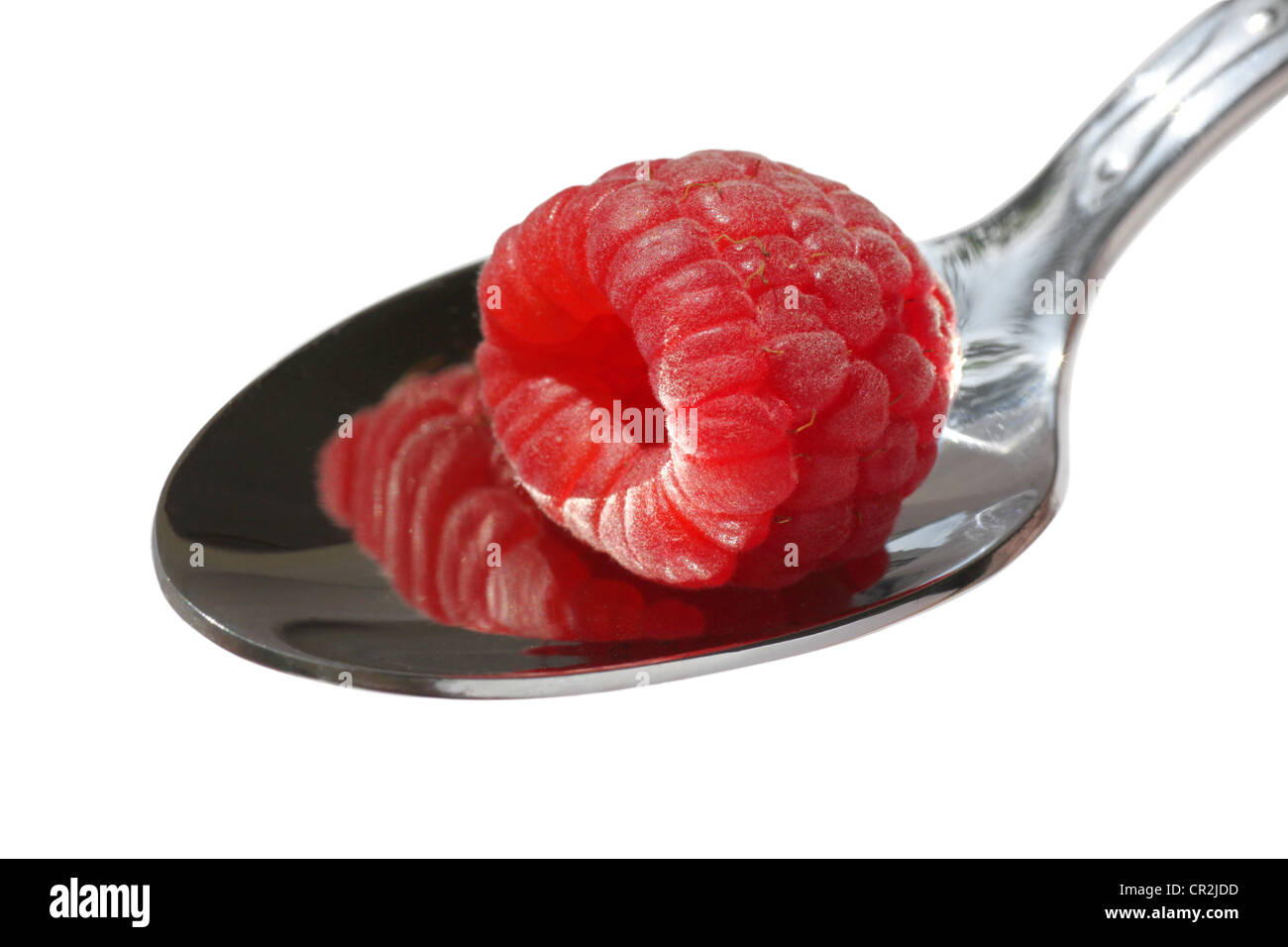 close up of raspberry on a spoon over white Stock Photo