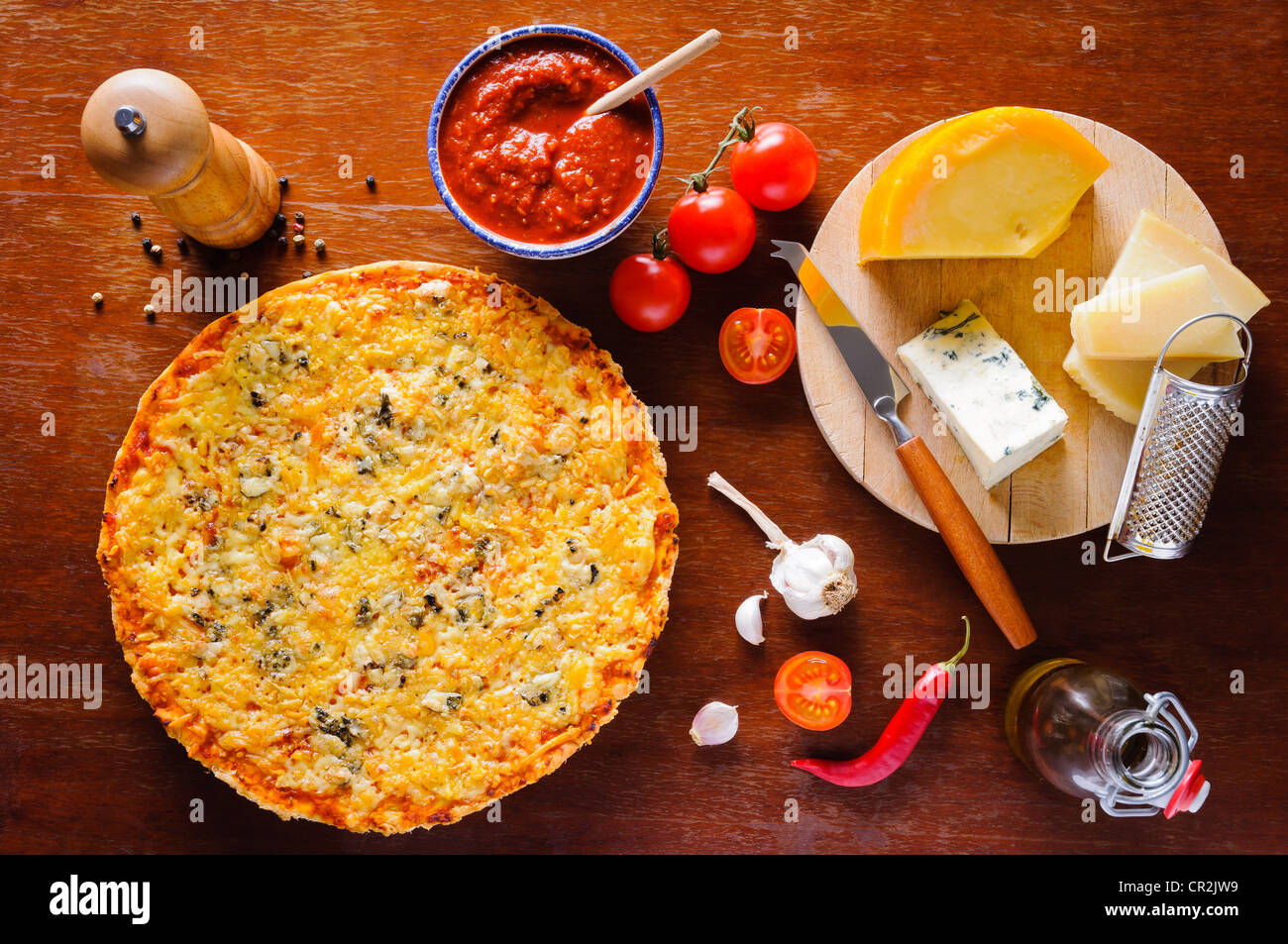 Traditional homemade italian quattro formaggi cheese pizza and ingredients Stock Photo