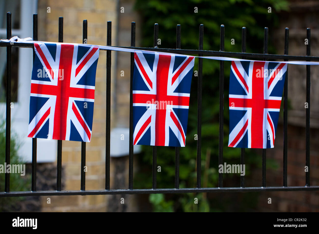 Union Jack bunting flags on a garden fence, UK Stock Photo Alamy