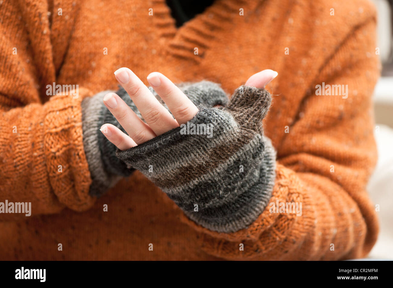 Hands Wearing Knitted Woolen Fingerless Gloves Stock Photo, Picture And  Royalty Free Image