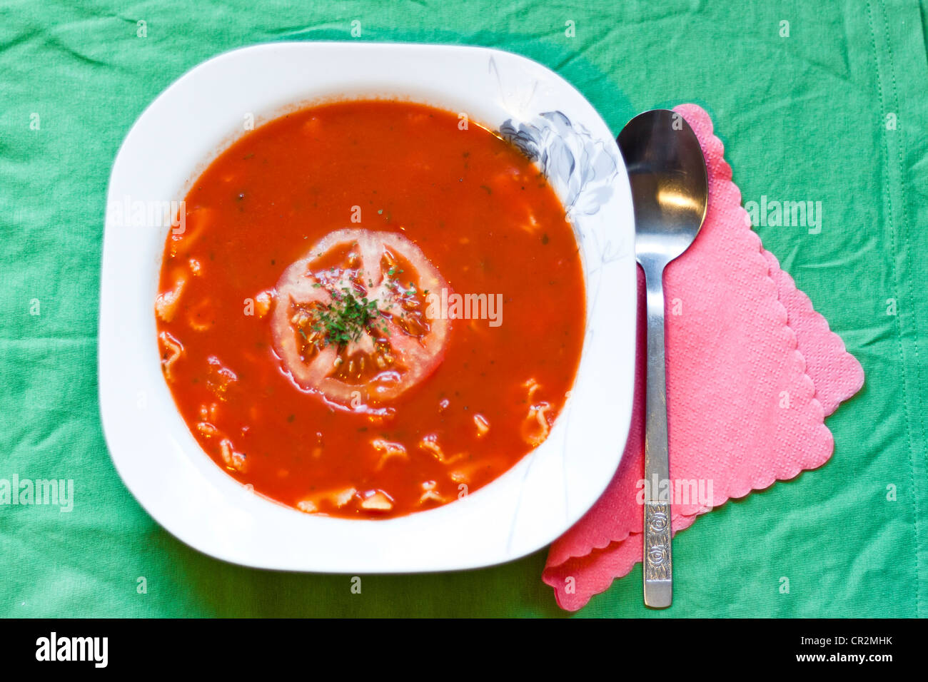 Tomato traditional soup on green table Stock Photo - Alamy