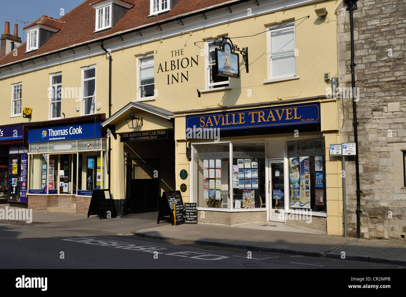 The Albion Inn public house in Wimborne Minster, Dorset. The entrance is flanked by two travel agents. Stock Photo