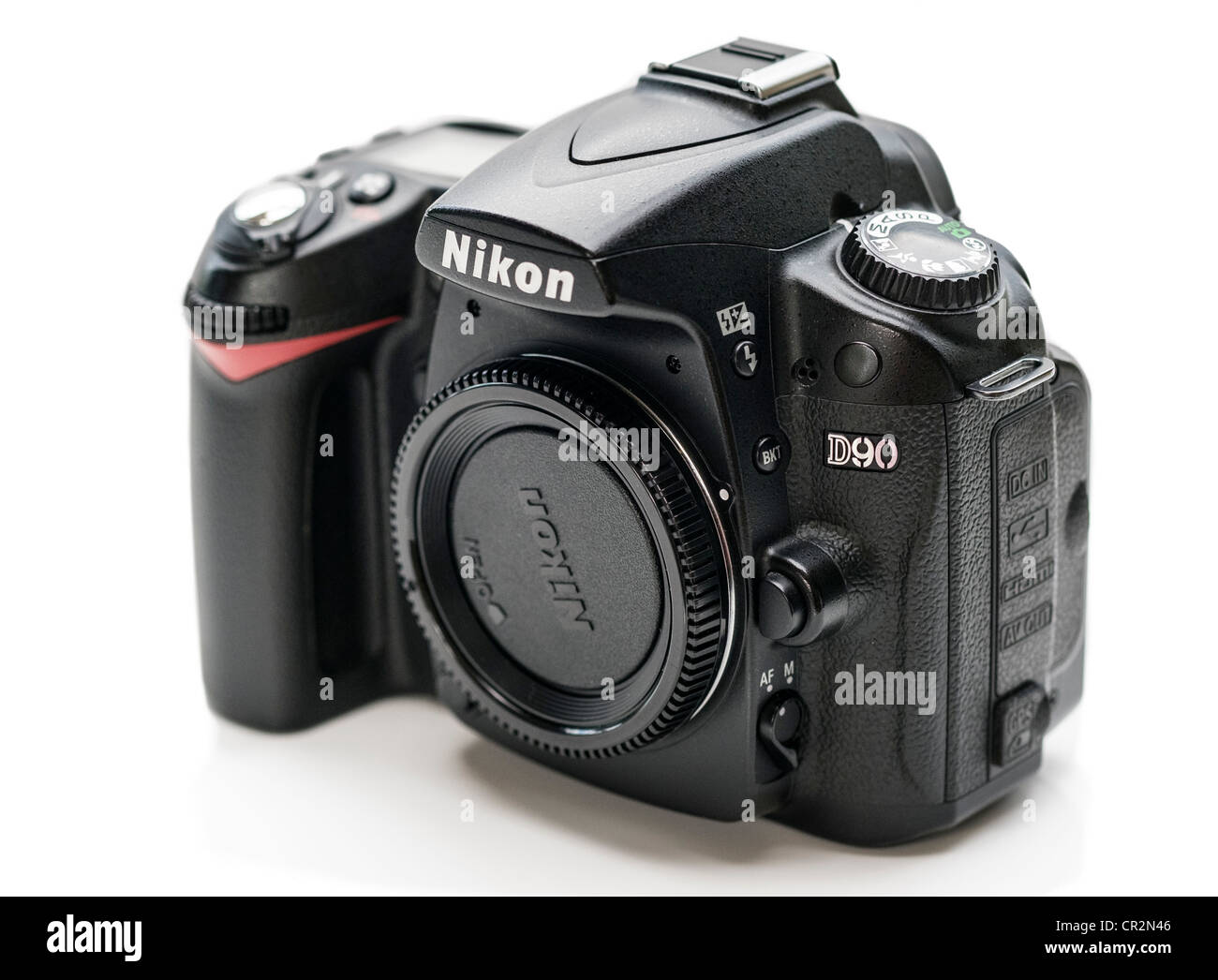 A used Nikon D90 DSLR Camera on a White Background Stock Photo