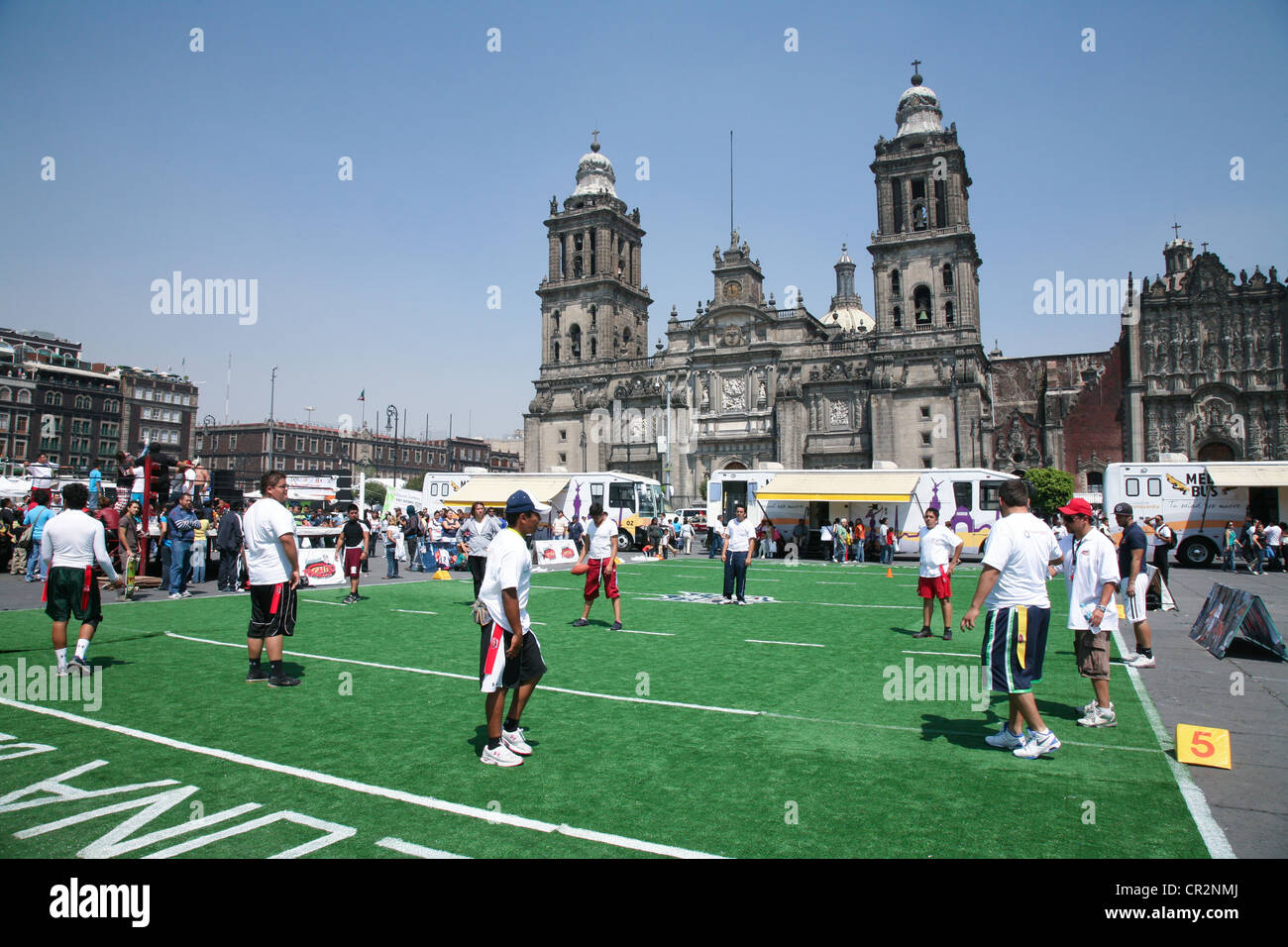 Mexican people play rugby on an artificial field on Zocalo in front of the Cathedral Metropolitana in Mexico City Stock Photo