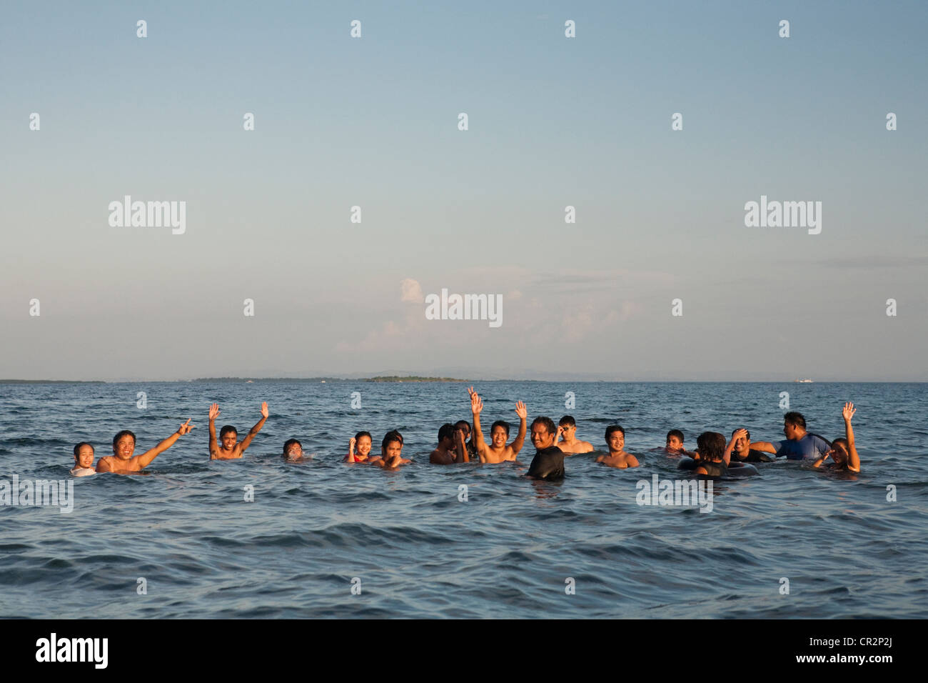 Filipinos swimming in the ocean at Palm Beach. Lapu-Lapu City, Metro Cebu, Mactan Island, Visayas, Philippines. Stock Photo
