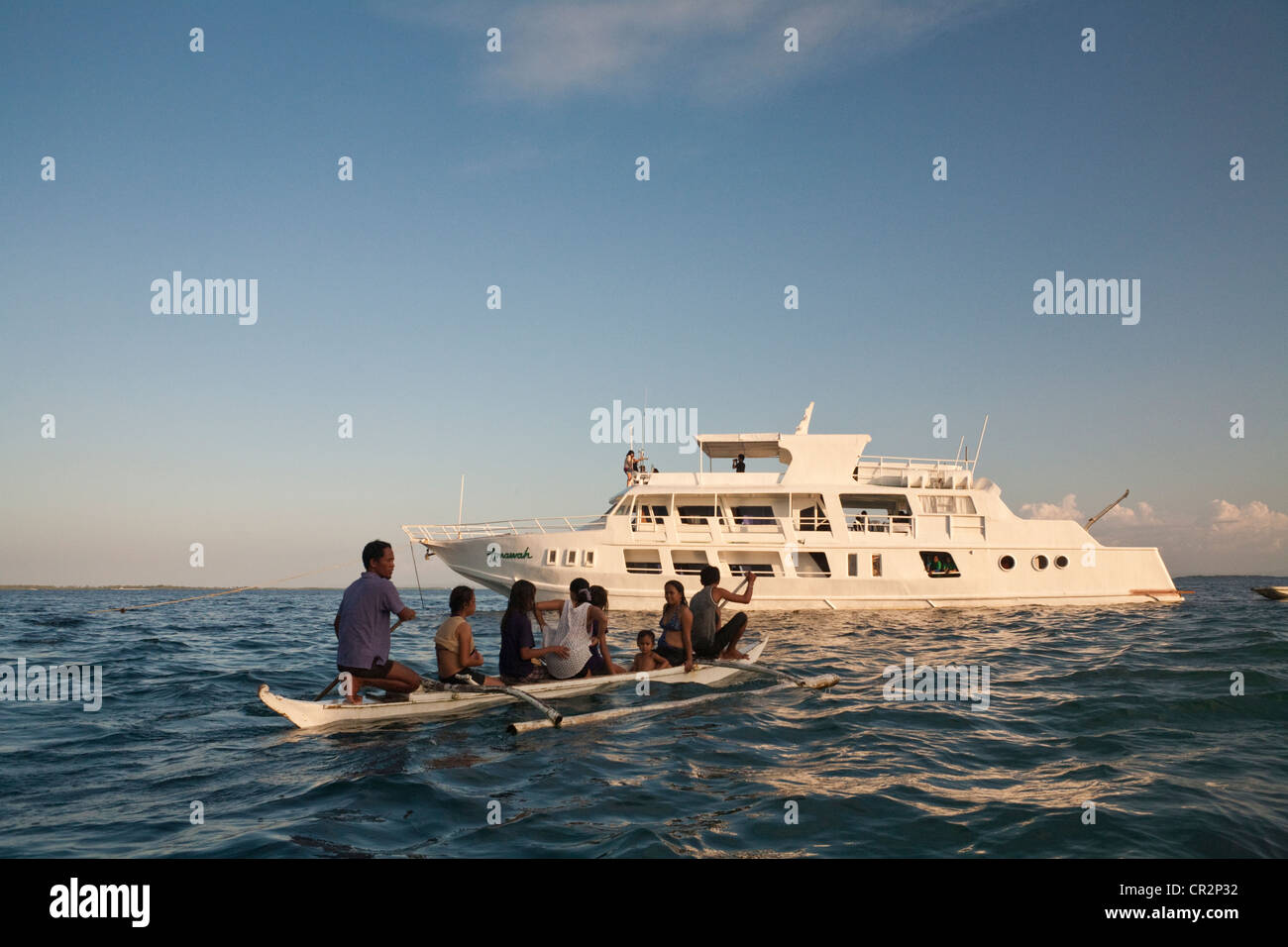 Filipinos on a Sakayan rowing boat at Blue Reef Mactan Island Resort. Lapu-Lapu City, Metro Cebu, Mactan Island, Visayas, Philip Stock Photo