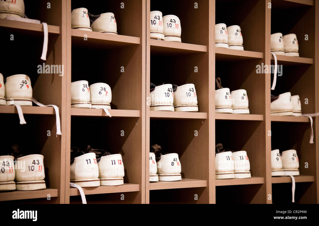 White bowling shoes on racks Stock Photo