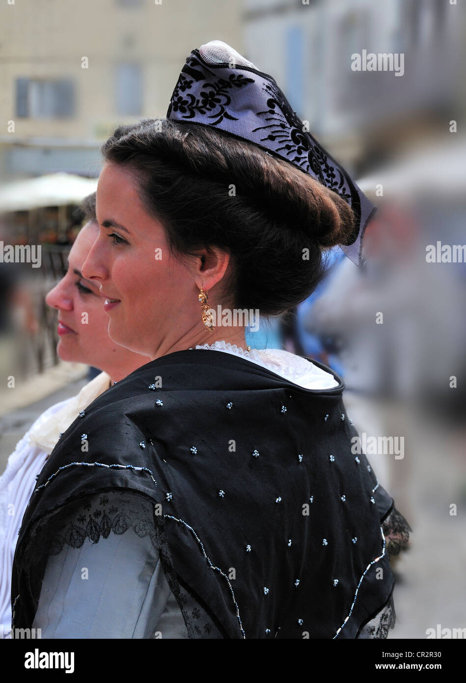 Arlesian woman dressed in traditional clothes at the Fete des Gardians festival in the Roman city of Arles, Provence, France Stock Photo