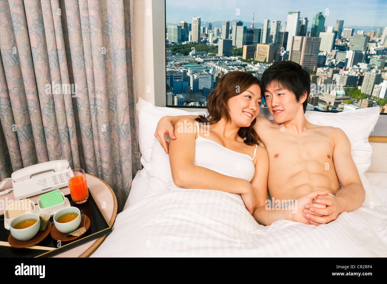 Couple in hotel room with view Stock Photo