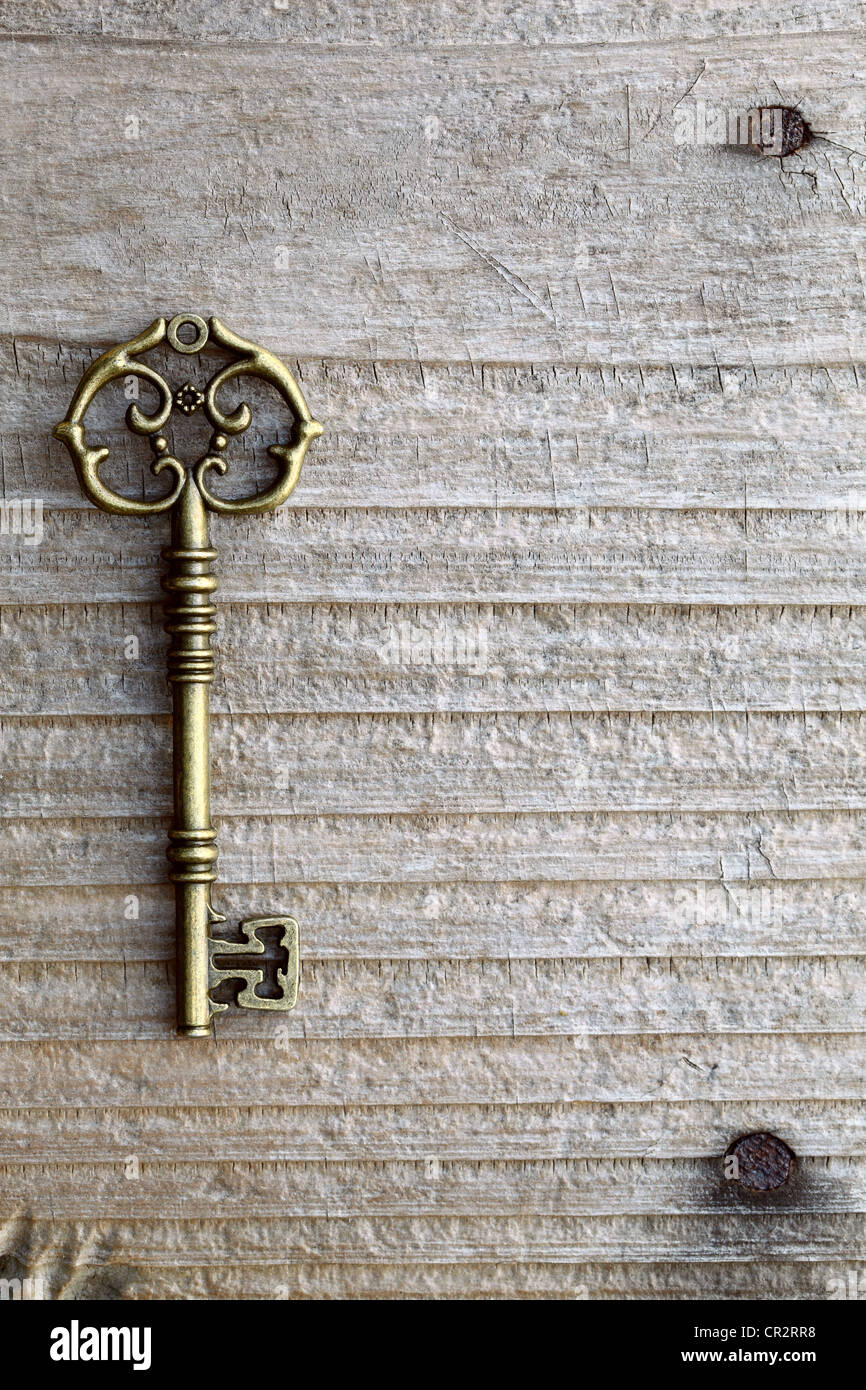 Antique key on wooden background Stock Photo