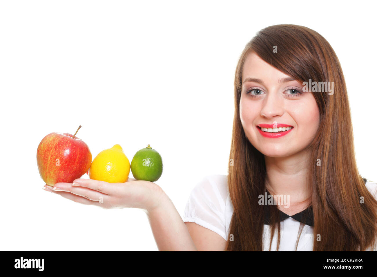Young smiling woman with fruits and vegetables. Over white background ...
