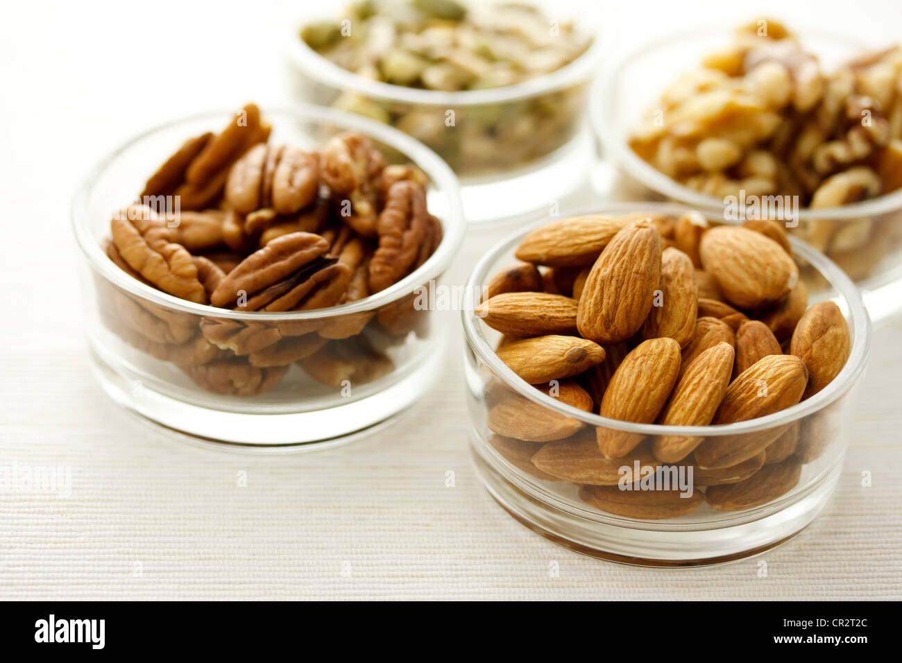 Assortment of nuts in glass containers Stock Photo
