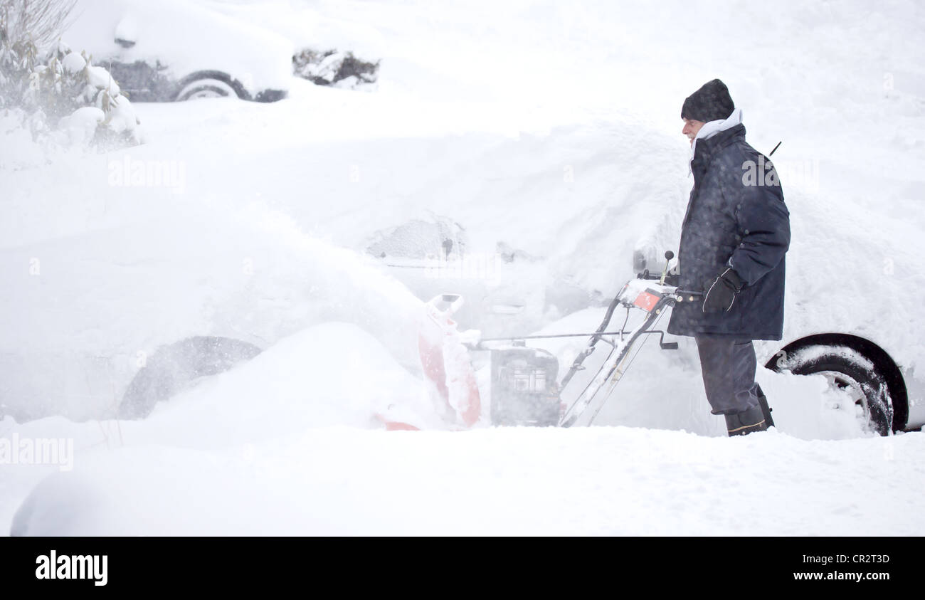 Man with Snowblower during snow storm Stock Photo