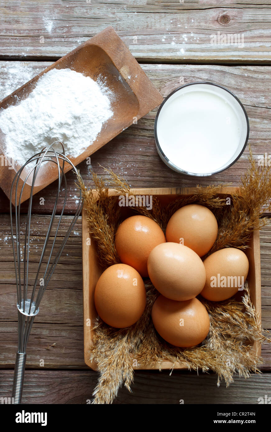 Eggs, flour, milk and whisk Stock Photo Alamy