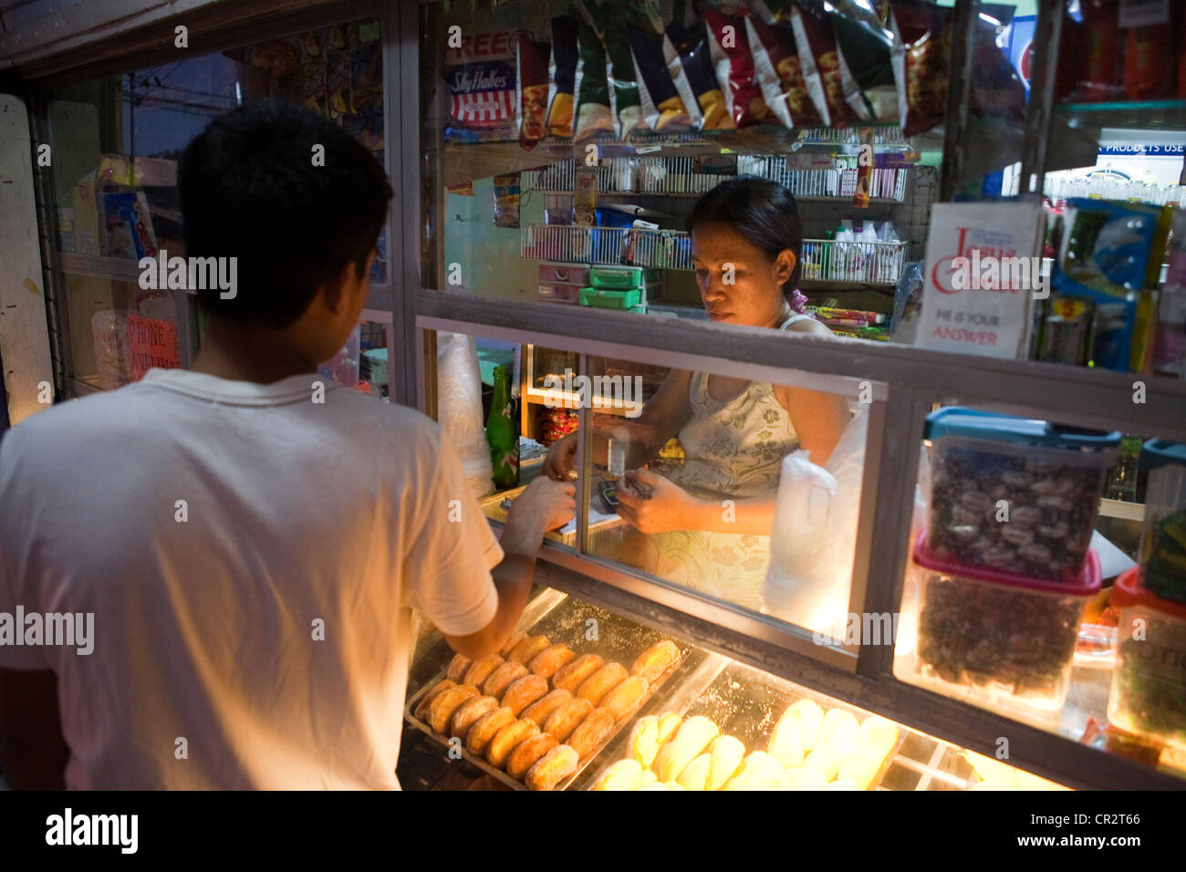 Man shopping at a sari-sari store and bakeshop. Lapu-Lapu City, Metro Cebu, Mactan Island, Visayas, Philippines. Stock Photo