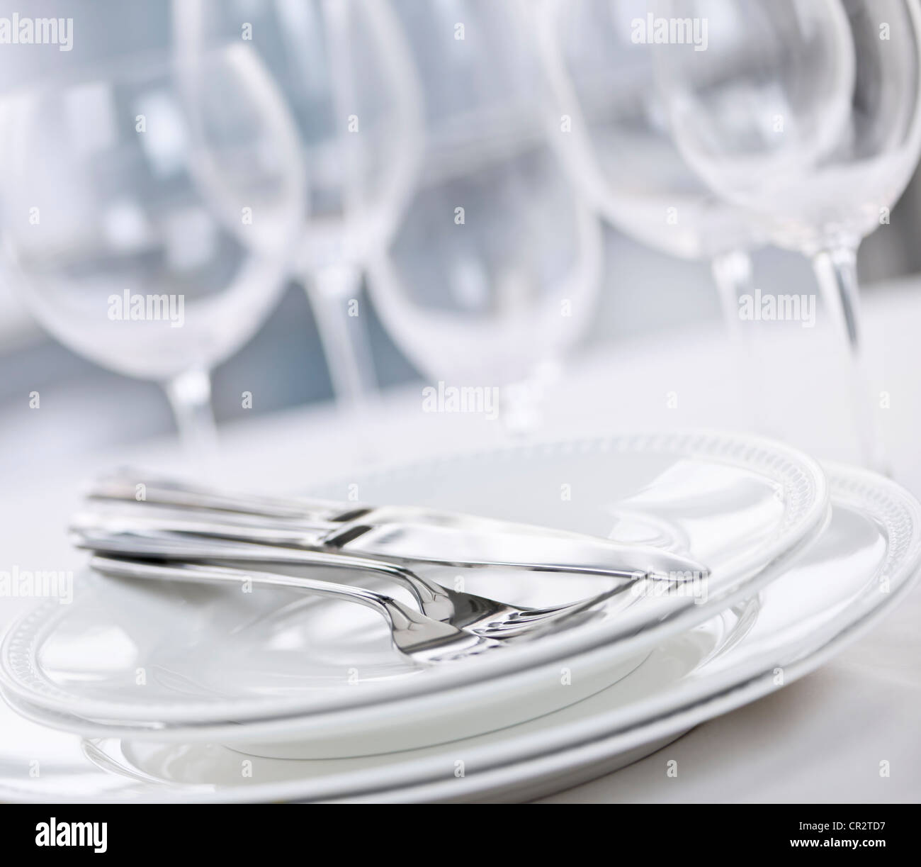 Elegant restaurant table setting with plates cutlery and stemware ... Elegant restaurant table setting with plates cutlery and stemware ...