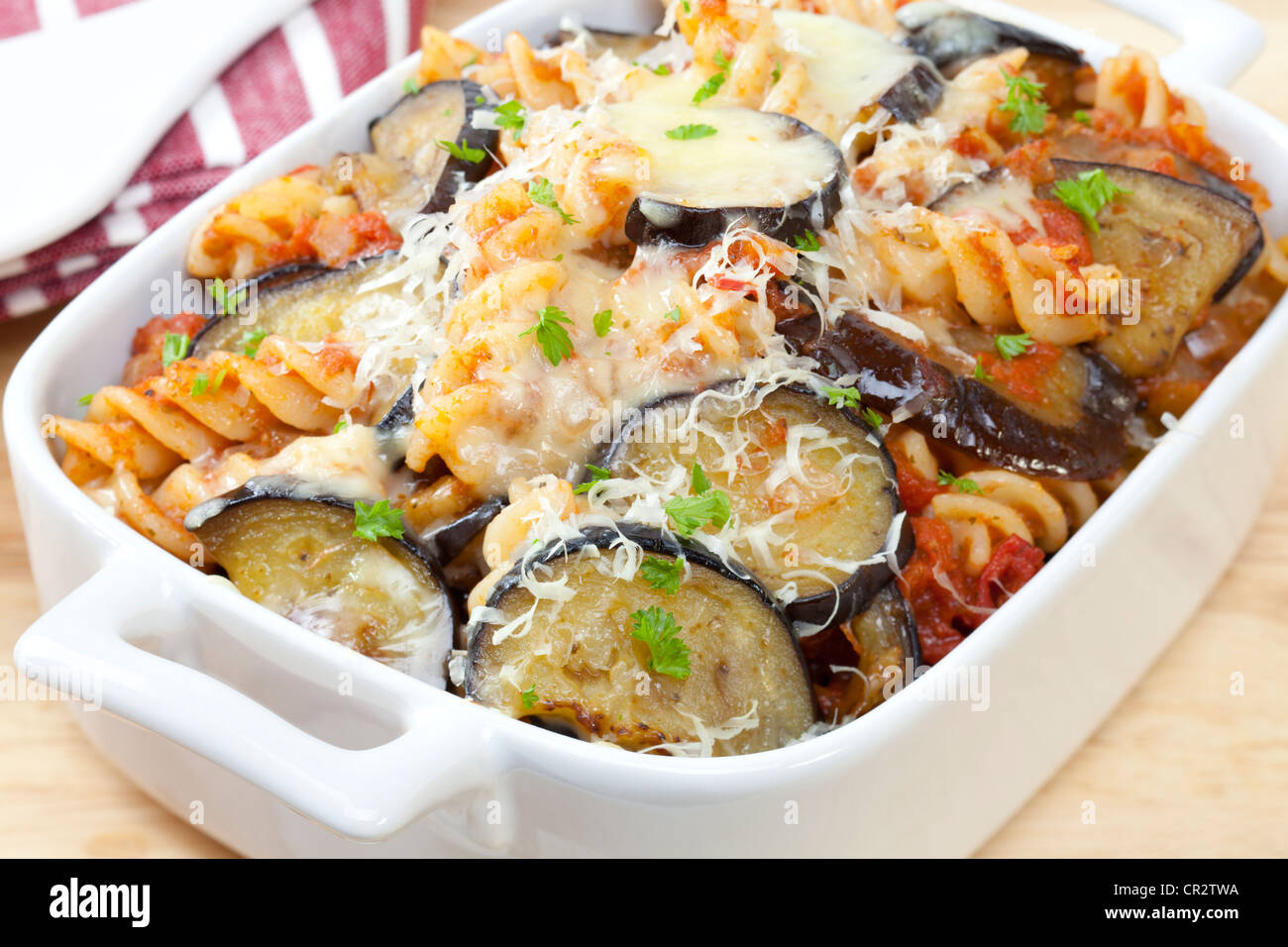 Pasta bake, with tomato sauce, eggplant fried in olive oil, mozzarella and parmesan on top. Stock Photo