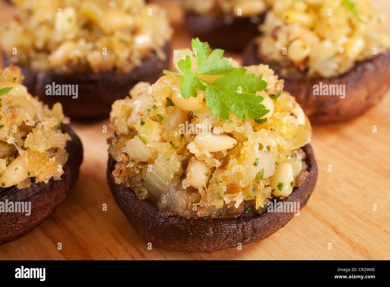 Portobello mushrooms stuffed with a mixture of pine nuts, onion, garlic and cheese. Stock Photo