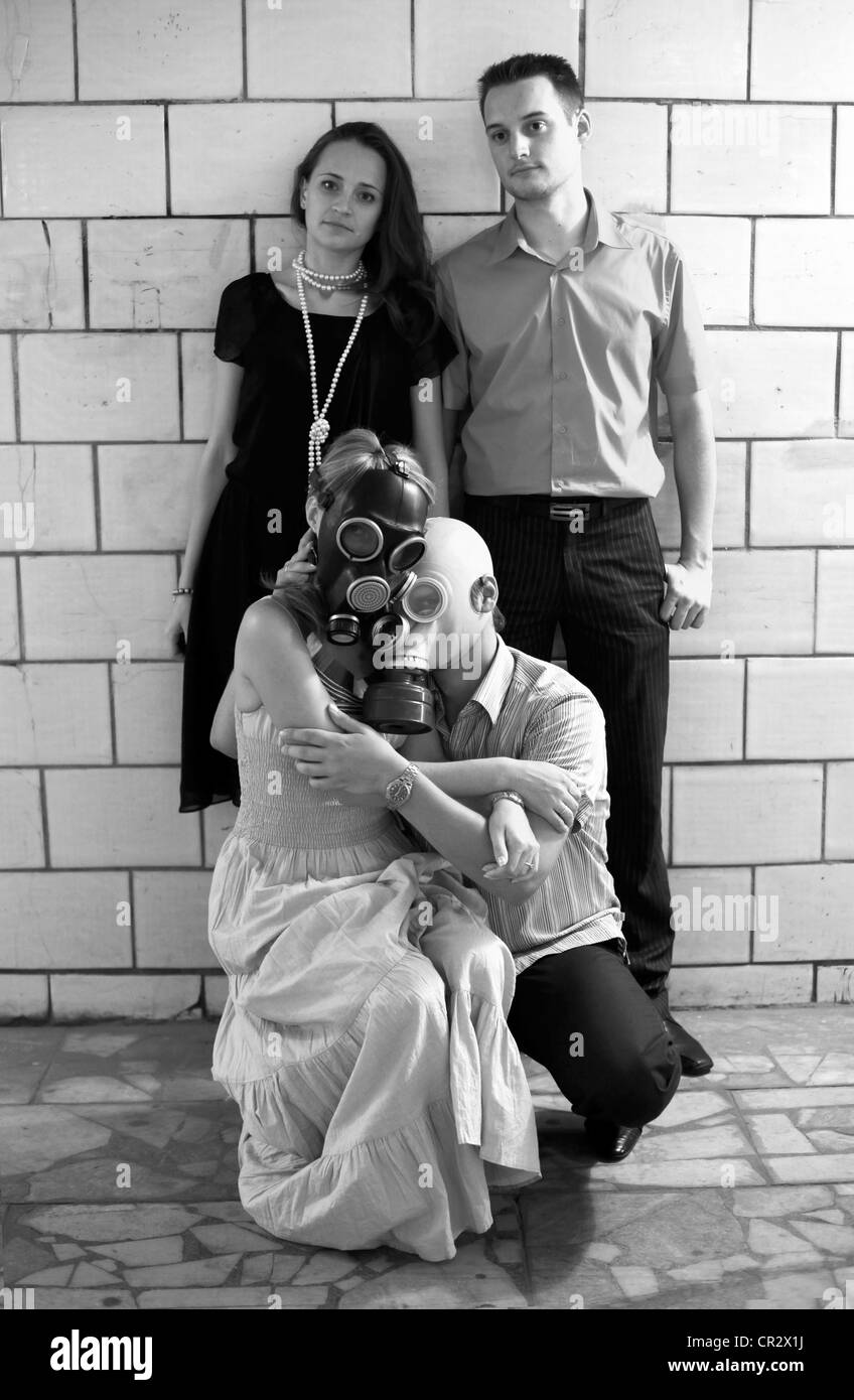 Two married couples in a tunnel, one of pairs in gas masks Stock Photo