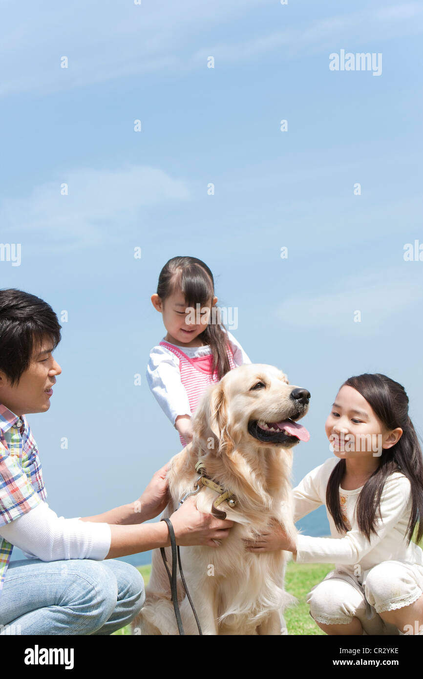 Father,  Two Daughters and Dog Stock Photo