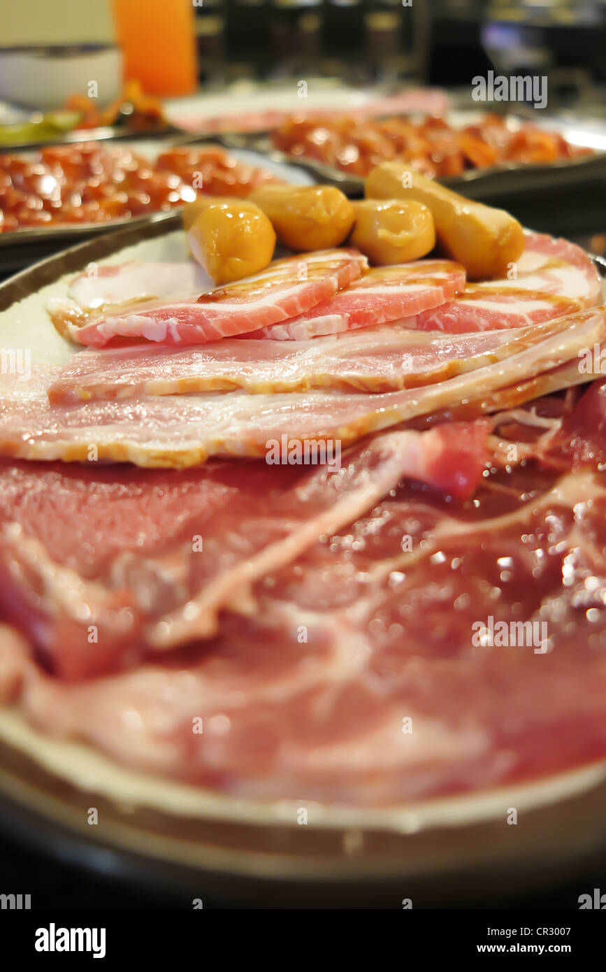 raw sausage and fresh sliced pork and beef prepare for cooking. Stock Photo