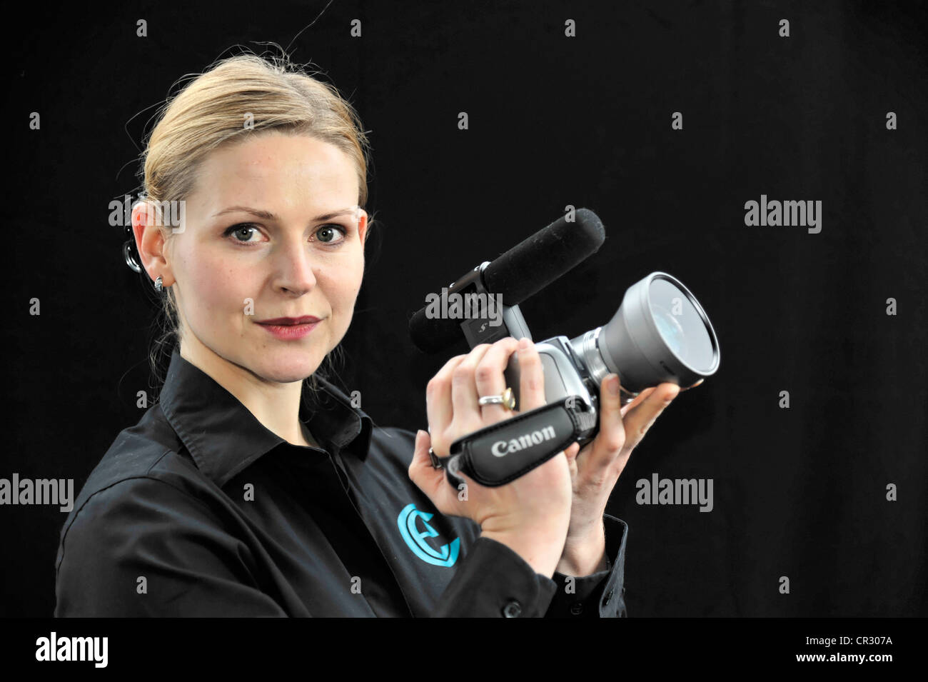 Young professional videographer shooting with a film camera Stock Photo