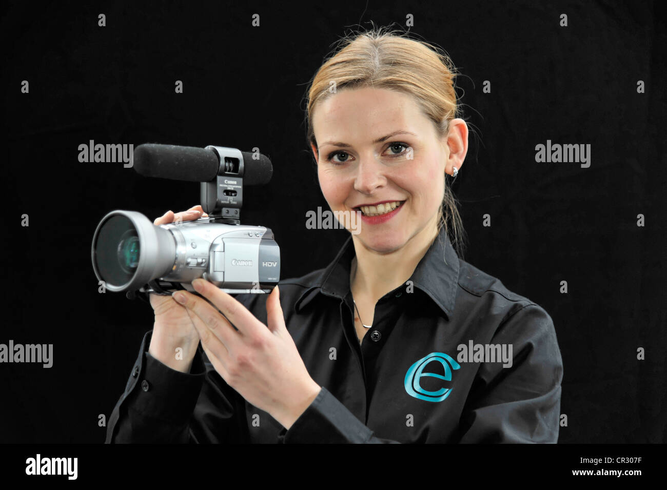 Young professional videographer shooting with a film camera Stock Photo