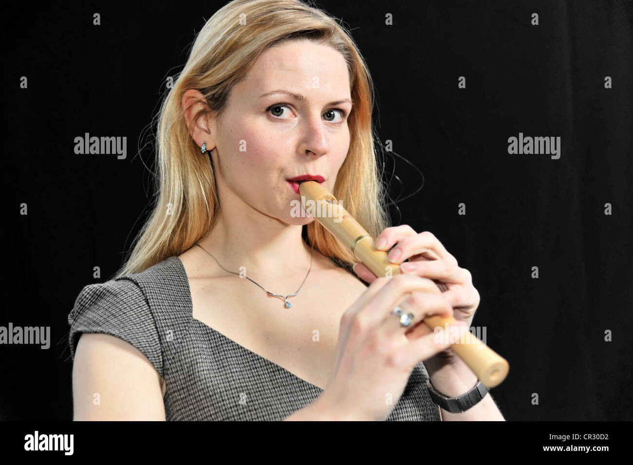 Young woman playing the recorder Stock Photo Alamy