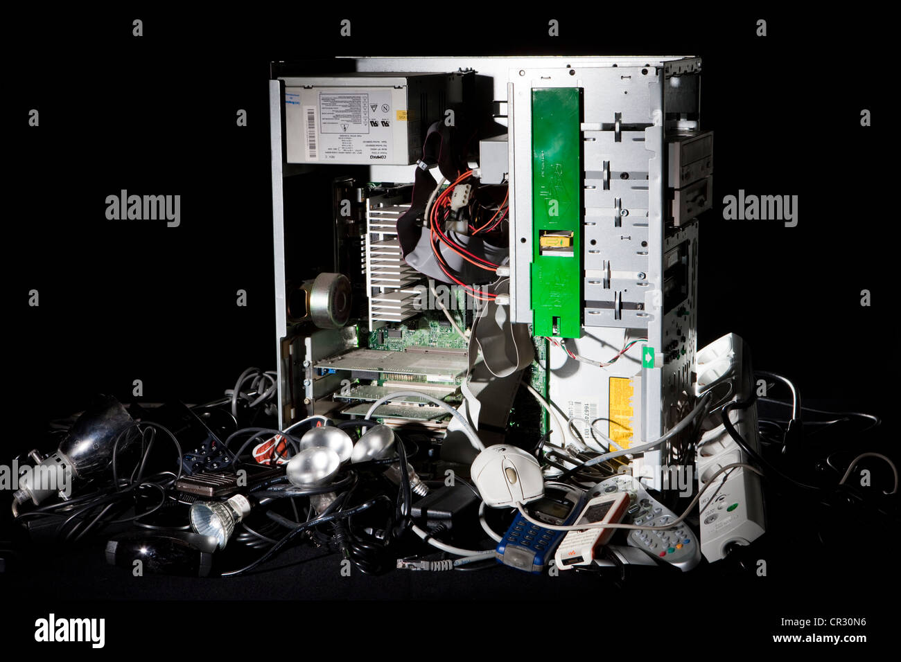 Electronic scrap, computer, cable, phone, light bulbs, mouse Stock Photo