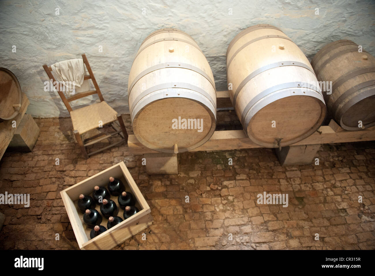 Wine barrels and crate of wine bottles in a room on Thomas Jefferson's