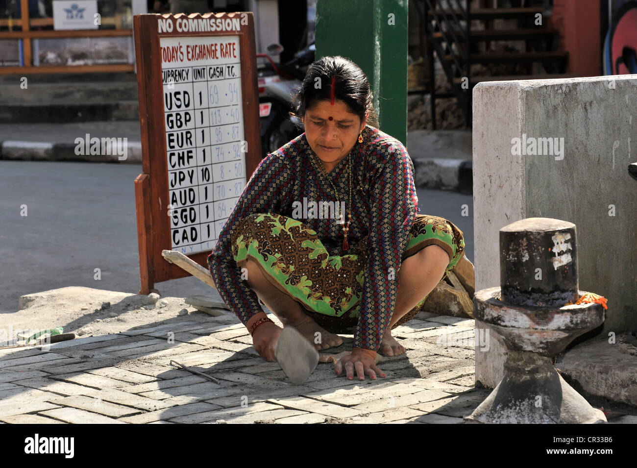 Nepalese woman repairing road damage, Pokhara, Nepal, Asia Stock Photo -  Alamy