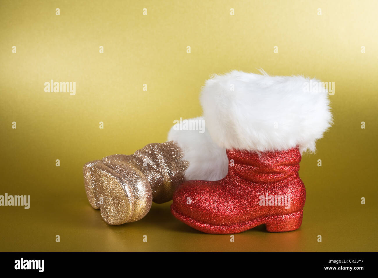 Pair of Santa boots on gold background Stock Photo - Alamy