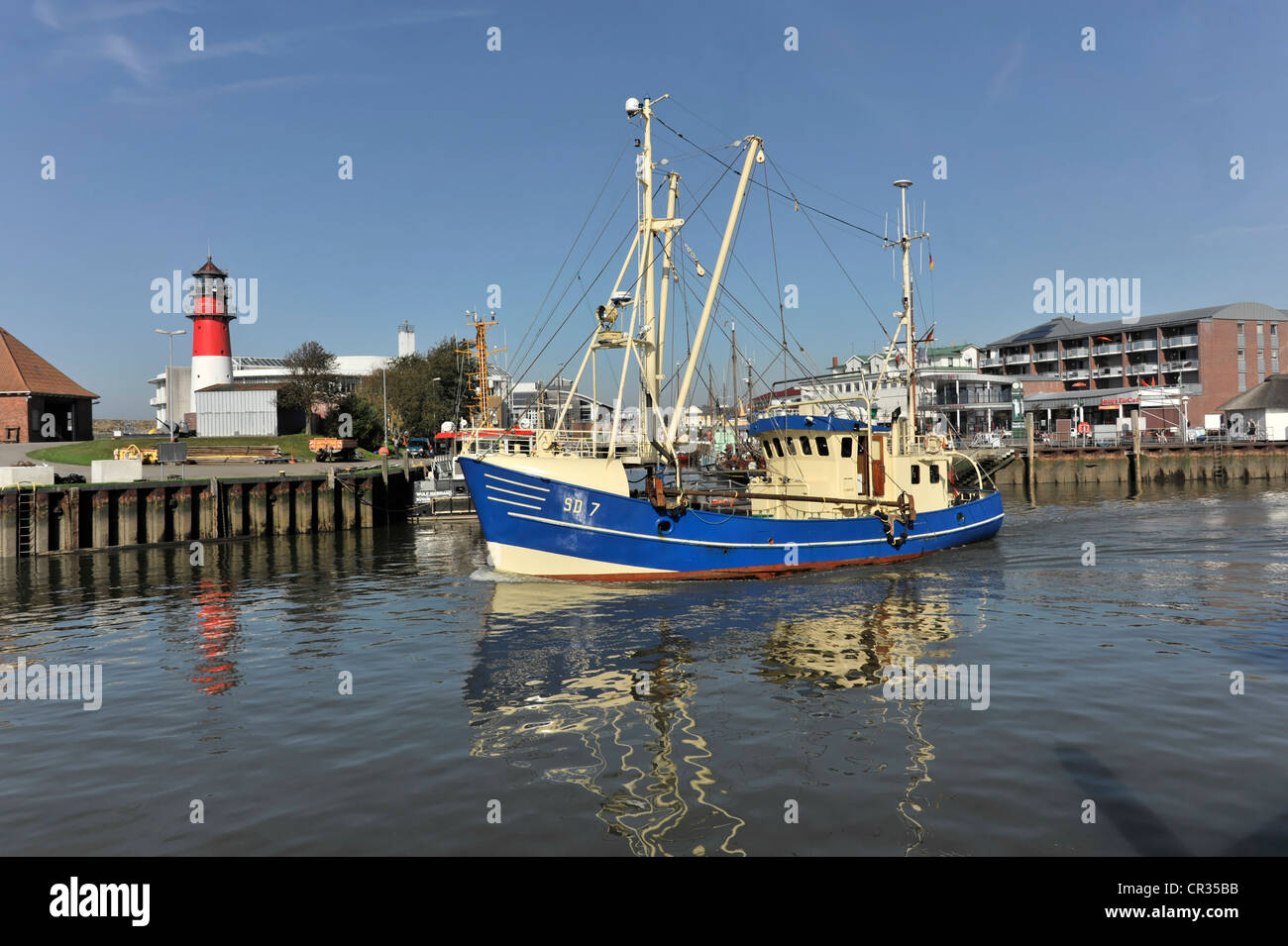Shrimp cutter in the port of Buesum, with Buesum Lighthouse on the left, Schleswig-Holstein, Germany, Europe Stock Photo